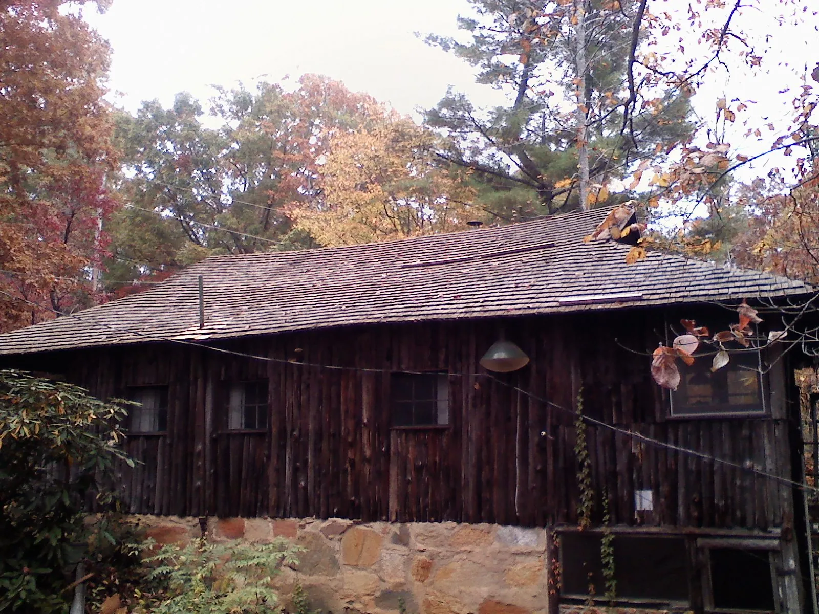 Weathered wood shake roof on a rustic board sided cabin in Coudersport